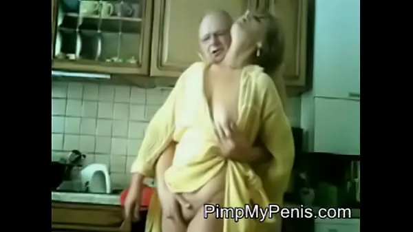 Show old couple having fun in cithen warm Clips